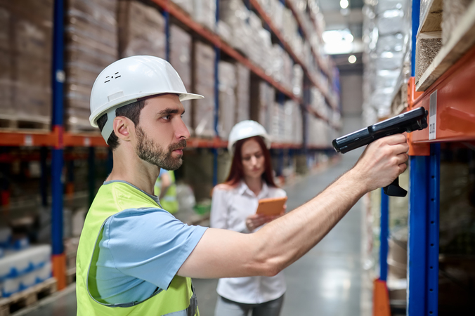 Field technician using a tablet in an industrial environment